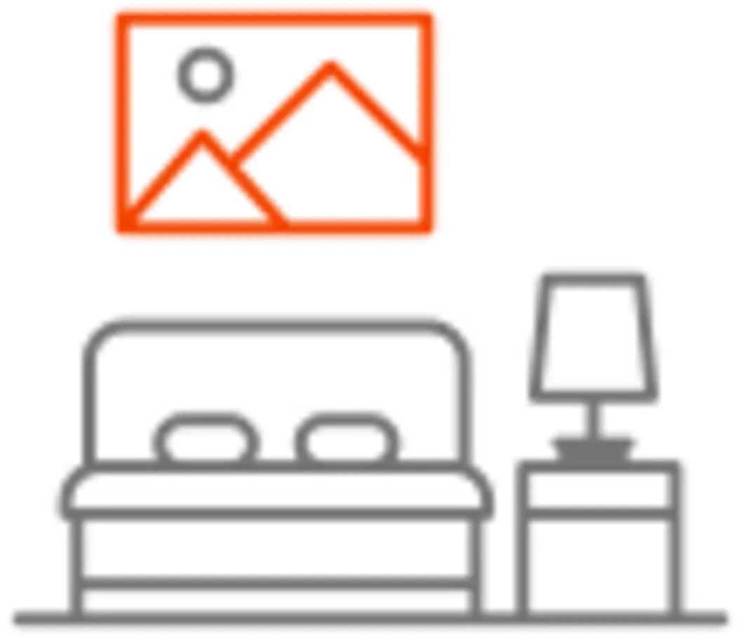A minimalistic illustration of a bedroom featuring a bed with pillows, a nightstand with a lamp, and a picture frame above the bed displaying a mountain and sun scene. The design is simple and line-drawn.