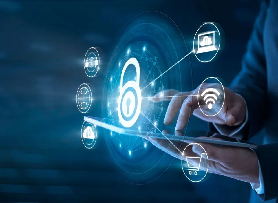 Business professional using a tablet with digital icons representing cybersecurity, cloud protection, and secure data access