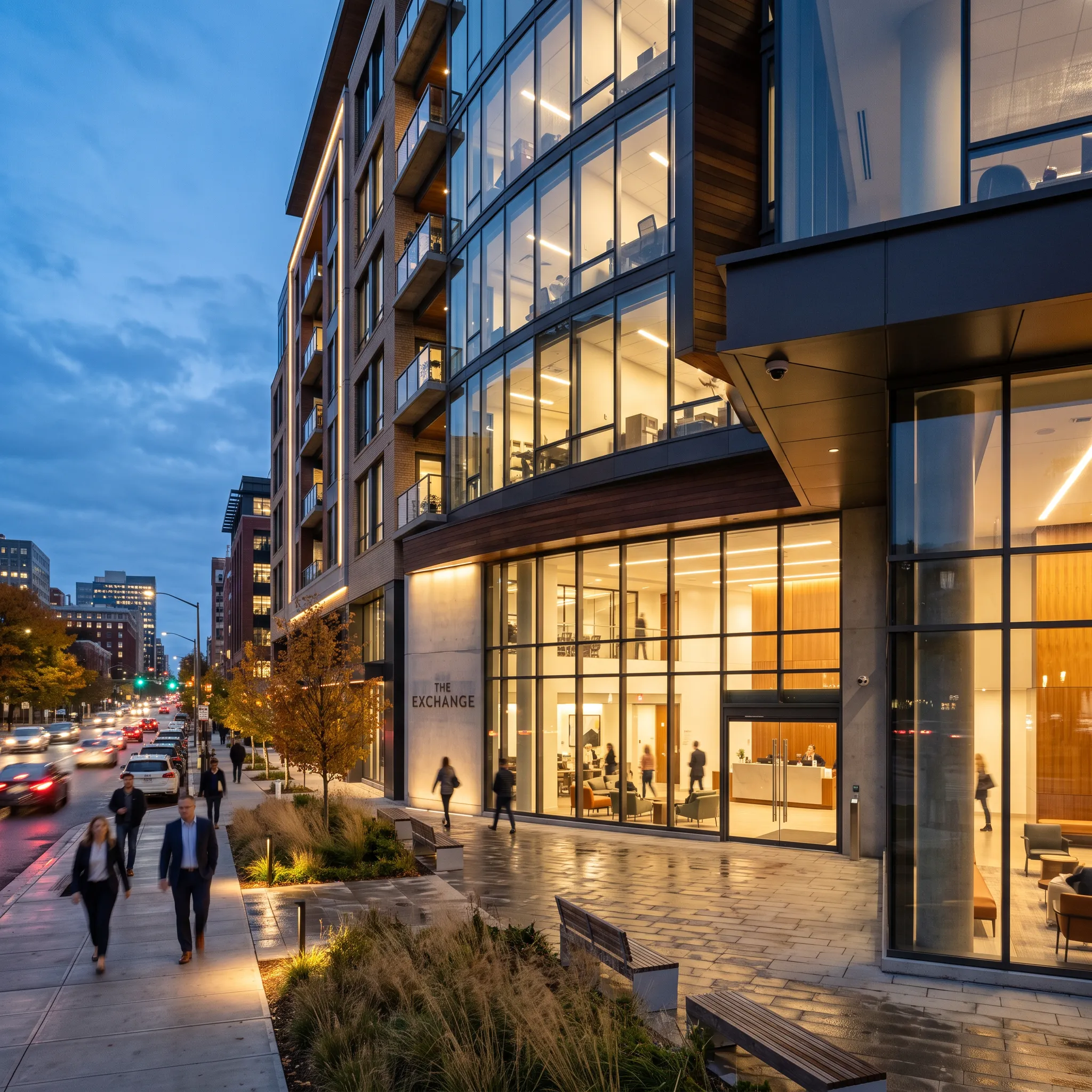 Mixed-use residential and commercial building at dusk with a camera covering the ground-floor entrance